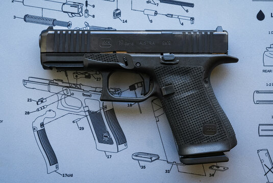 Tallinn, Estonia - February 20, 2026: A Glock 19 Gen 6 9mm pistol resting on a technical gun cleaning mat.