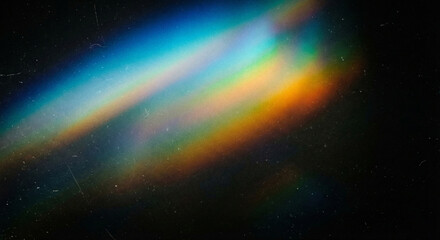 Vibrant rainbow light beam shining diagonally across a dark background with colorful spectrum