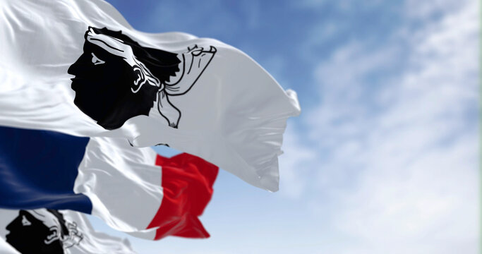 Flags of Corsica waving in the wind on a clear day