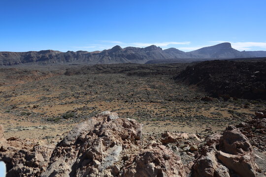 Panoramic view of volcanic rocks and vast arid landscape in Teide National Park Tenerife under clear blue sky. Dramatic nature scenery expressing freedom, solitude and awe. Captured by Canon R6 Mark I