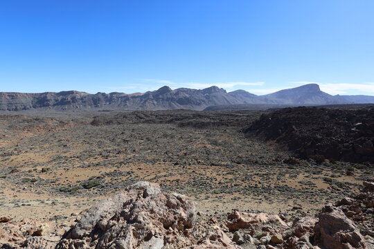 Panoramic view of volcanic rocks and vast arid landscape in Teide National Park Tenerife under clear blue sky. Dramatic nature scenery expressing freedom, solitude and awe. Captured by Canon R6 Mark I