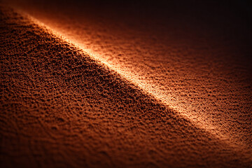 Macro of warm brown powder with a diagonal highlight creating a dramatic ridge. Rich earthy tone and fine particles look clean and premium. Great for cosmetic texture or cocoa-like background.