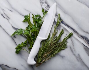 white kitchen knife on marble surface with herbs