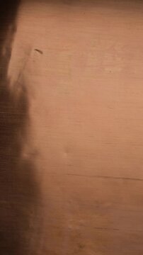 The copper surface is shaded on the left. Light originates from the right. Visual effect. Bright, shiny orange-red copper background.