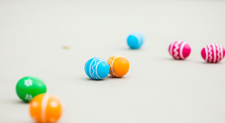 Colorful Easter eggs scattered on light surface with soft focus  