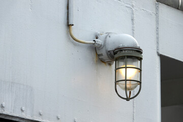 A light on a big ship wall