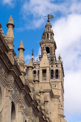 Fototapeta premium Close-up of Giralda tower and El Giraldillo statue in Seville Cathedral, Spain.