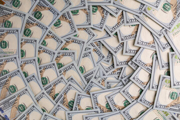 Obraz premium Background of Scattered One Hundred US Dollar Bills Representing Wealth and Finance