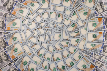 Obraz premium Background of Scattered One Hundred US Dollar Bills Representing Wealth and Finance