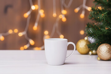 Fototapeta premium Mockup of a festive white mug with christmas tree and lights
