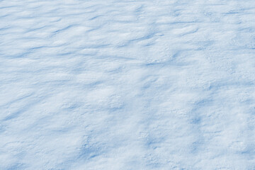 Natural snow surface texture with soft light and subtle shadows. Winter background with copy space, minimal seasonal backdrop.
