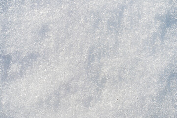 Obraz premium Natural snow surface texture with soft light and subtle shadows. Winter background with copy space, minimal seasonal backdrop. 