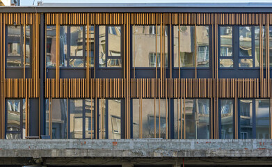 Retro building facade with closed glass windows outside on street