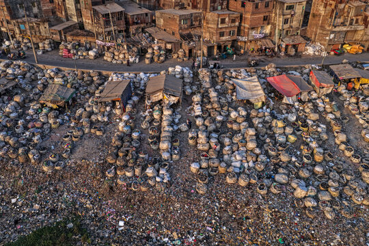 Dhaka, Bangladesh - 05 February 2026: Aerial view of the bustling Kawran Bazar, where countless baskets overflow with vibrant produce under the warm glow of the setting sun.