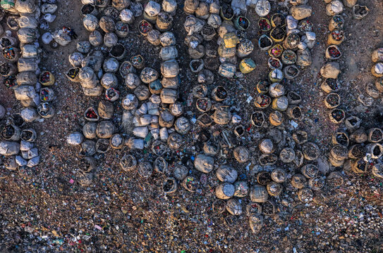 Dhaka, Bangladesh - 05 February 2026: Aerial view of countless discarded items scattered across the landscape, a stark contrast of textures and tones under the open sky.