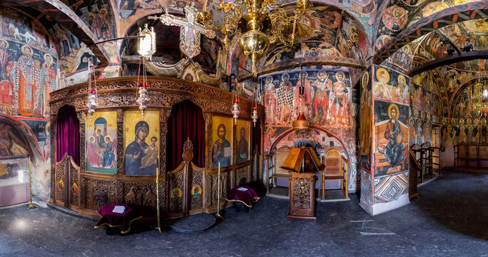 Aerial view of vibrant frescoes and intricate carvings adorn the walls and ceiling of a historic orthodox church, creating a rich tapestry of color and texture, Kalabak, Trikala, Greece.