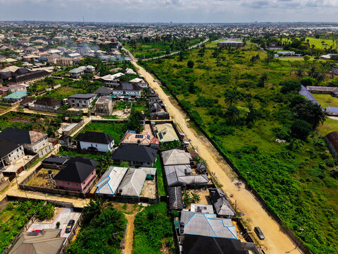 Aerial view of roads cutting through neighborhoods and lush green spaces, a vibrant mix of urban and natural elements, Port Harcourt, Rivers, Nigeria.