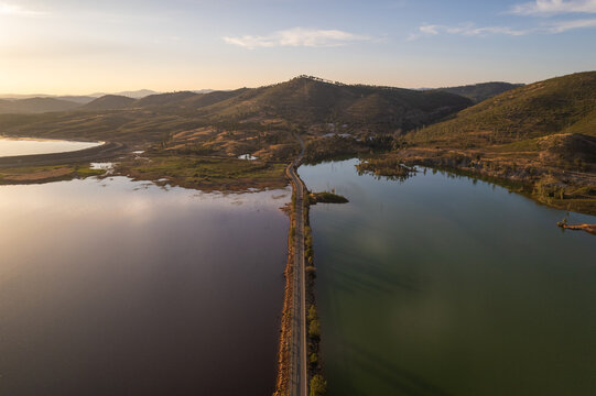 Aerial view of a stark contrast between dark and light bodies of water divided by a narrow strip of land, Minas de Riotinto, Andalusia, Spain.