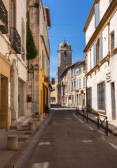 Obraz premium Old residential houses with stone walls, green shutters and small stairway in a quiet village of Provence, southern France under clear blue sky