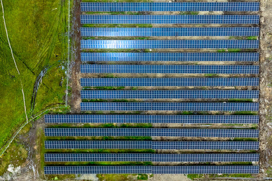 Aerial view of solar panels contrasting against the earthy tones of the surrounding terrain, creating a blend of technology and nature, Chemaito, Bhutan.