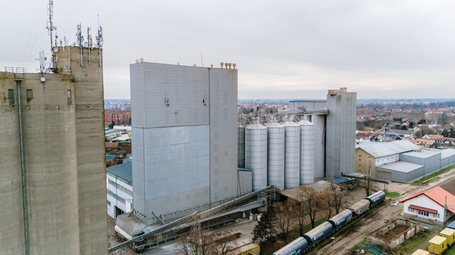 Aerial view of the industrial complex, its stark concrete contrasting with the muted colors of the surrounding urban sprawl, Sremska Mitrovica, Vojvodina, Serbia.