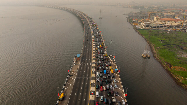 Aerial view of the Third Mainland Bridge teeming with cars amid the murky waters, a vital artery connecting communities, Lagos, Lagos, Nigeria.