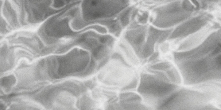 Abstract black and white image of rippling water surface with dynamic light reflections high quality professional