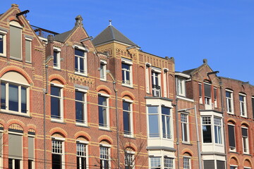 Fototapeta premium Brick House Facades Against a Blue Sky in Amsterdam, Paulus Potterstraat, Netherlands