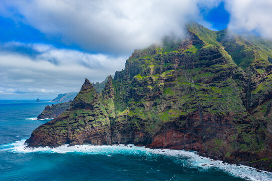 Aerial tracking shot over the rugged Anaga Massif peaks and the prehistoric barrancos of Punta del Hidalgo