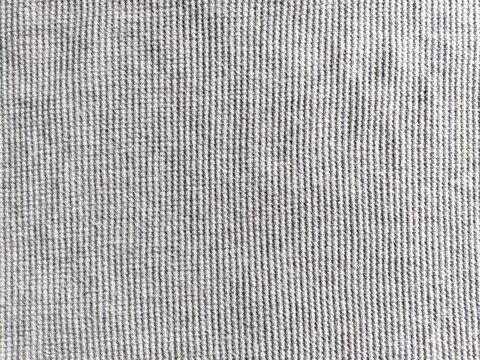 ​Gray waffle knit fabric texture background, seamless cotton textile pattern, close-up macro.