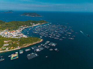 Coastal village with surrounding floating fish farms and boats Vietnam © Parilov