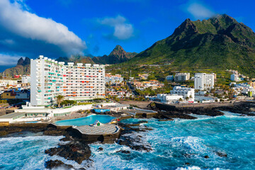 Fototapeta premium Aerial sunset panorama of Punta del Hidalgo natural swimming pool and the rugged Anaga mountains in Tenerife North