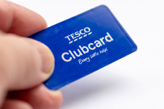 London. UK- February 15. 2026. A hand holding a Tesco Clubcard isolated on white.