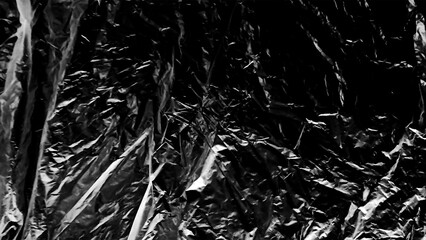 Plastic wrap texture overlay effect on black background. Shrink wrapped plastic sleeve for cover