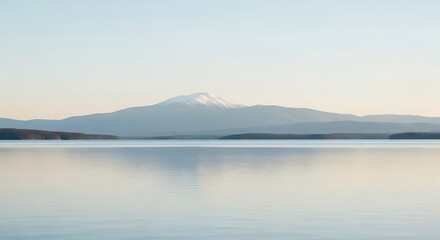 Fototapeta premium Serene Mountain Reflection in Calm Lake Water During Soft Early Morning Light