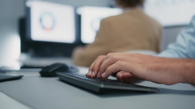 Close-up of Male Businessman Call Center, Customer Service Support Typing on Keyboard while working on customer support, talking with client and working on desktop computer at office.