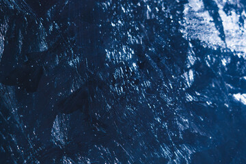 Close up view of intricate frosty patterns and snow on a glass surface, capturing the cold winter...