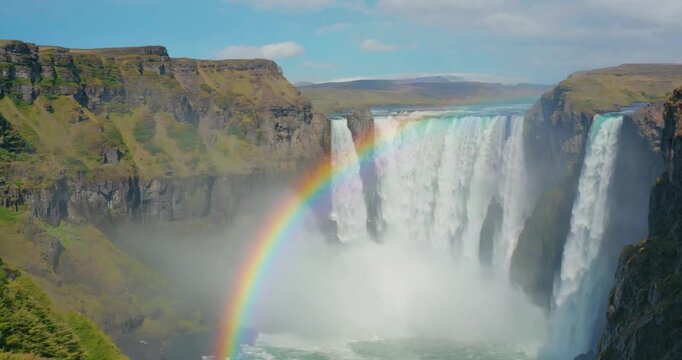 Iceland Flag Near Waterfall with Rainbow