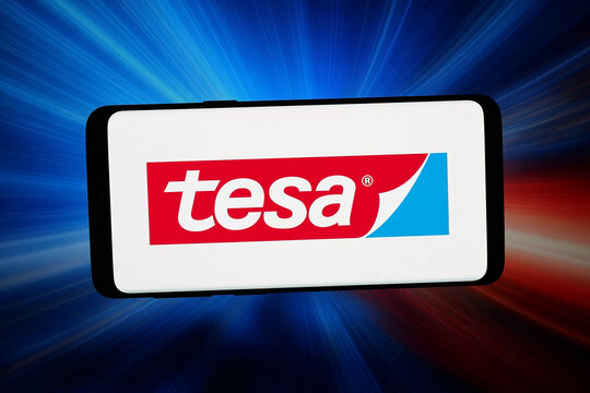 Stuttgart, Germany - 02-16-2026: In this photo illustration, the logo of German adhesive products company Tesa SE is displayed on a smartphone in front of abstract background on computer screen.