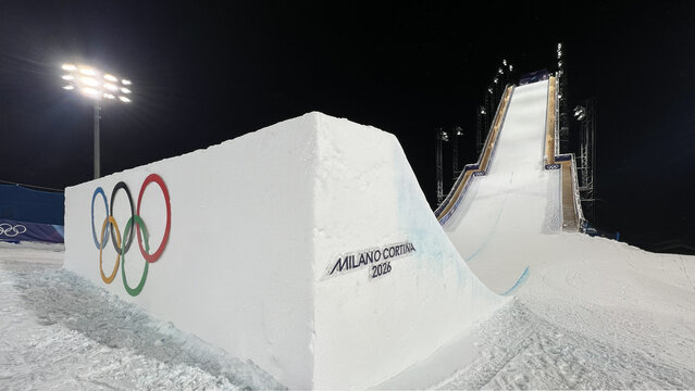 Livigno, Italy - February 17, 2026: Olympic rings and freestyle ski jump at Livigno Aerials and Moguls Park during Milano Cortina 2026 Winter Olympic Games at night