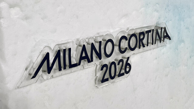 Livigno, Italy - February 17, 2026: Milano Cortina 2026 sign on snow wall at Livigno Aerials and Moguls Park during Winter Olympic Games