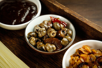 Fototapeta premium Guangxi Snail Dish with Pickled Bean Curd Vermicelli and Traditional Chinese Ingredients