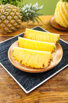 Fresh Sliced Pineapple from Guangdong Zhanjiang Xuwen - Sweet Tropical Fruit with Large Crisp Flesh on Wooden Serving Plate