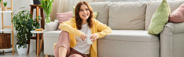 Woman in a bright yellow cardigan enjoying a cozy spring moment at home