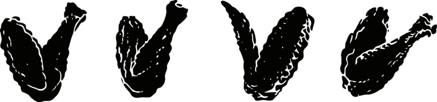 set of four black silhouettes of chicken wings in different angled positions isolated on white