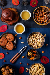 Fototapeta premium Food themed still life with crockery, various nuts and tea. Flat lay. Top view.