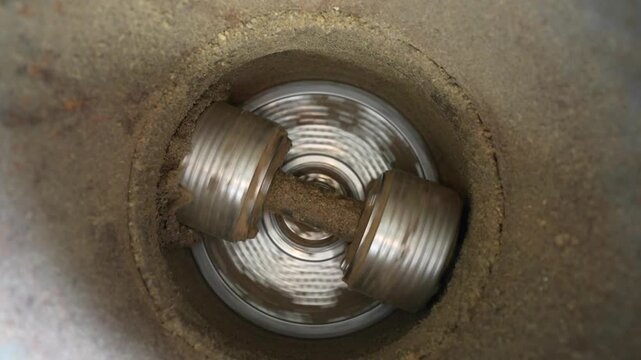 Granulator machine processes material with rotating blades, showcasing continuous action of grinding and mixing inside a cylindrical chamber