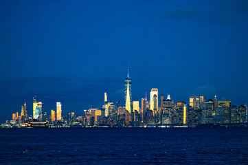 Obraz premium Manhattan skyline with One World Trade Center at night reflected in Hudson River New York City USA