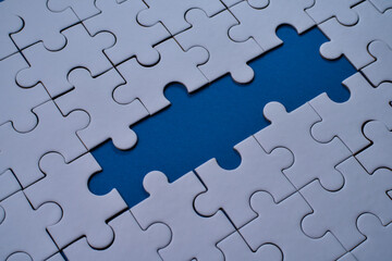 Obraz premium Missing piece highlights empty space in white jigsaw puzzle arrangement