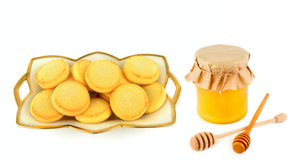 Golden Shortbread Biscuits and Honey Jar with Wooden Dippers
